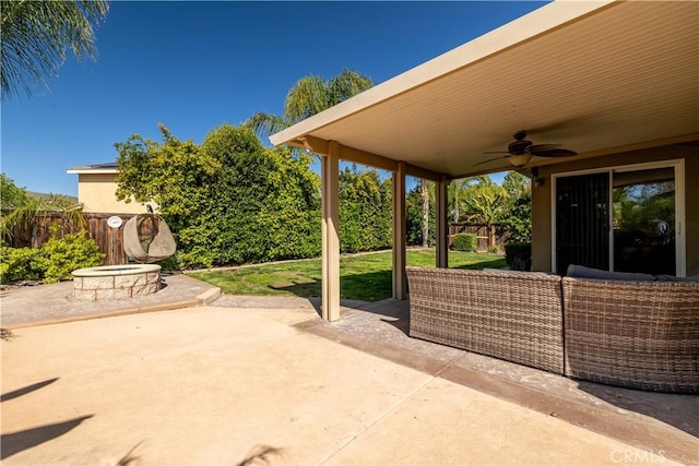 view of patio / terrace with a fenced backyard, ceiling fan, and an outdoor fire pit