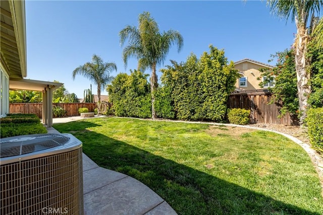 view of yard with central AC unit and a fenced backyard