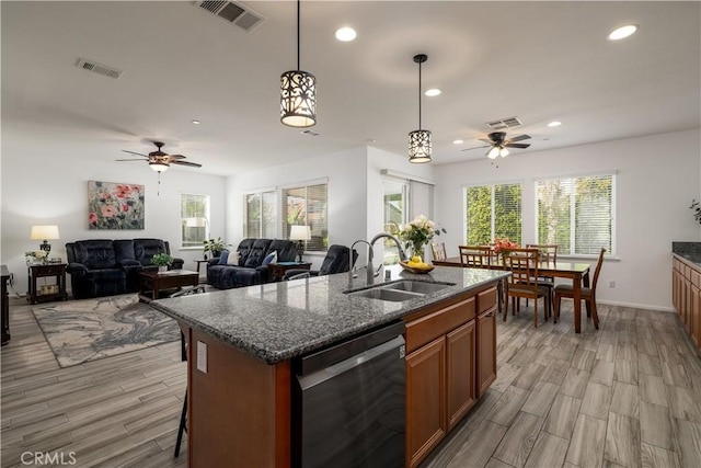 kitchen with a ceiling fan, visible vents, a sink, and dishwasher