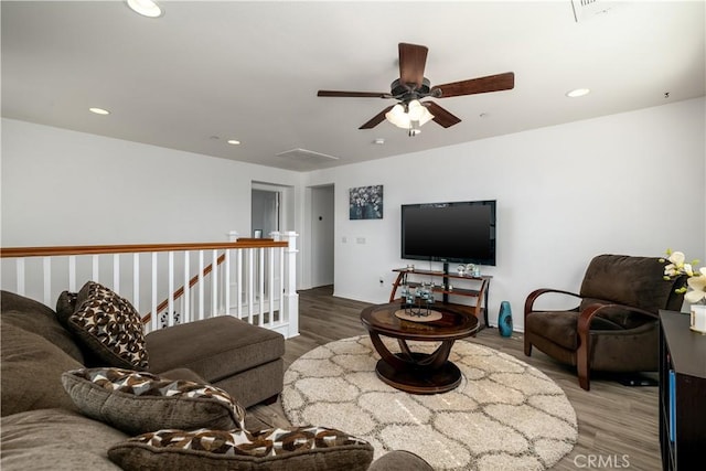 living area featuring recessed lighting, baseboards, ceiling fan, and wood finished floors