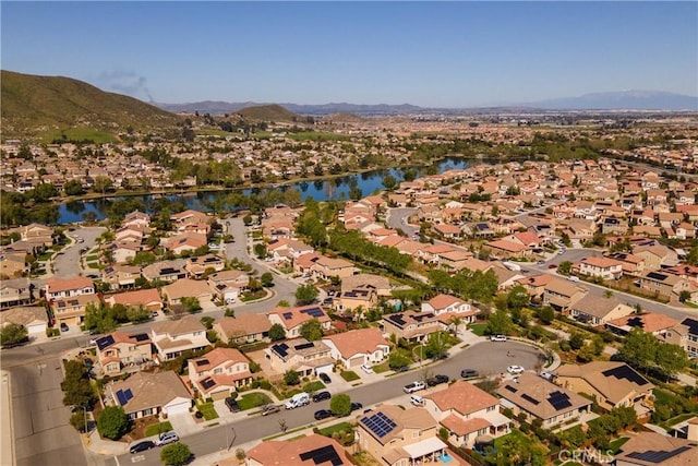 drone / aerial view with a residential view and a water and mountain view