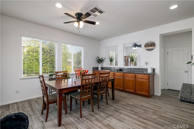dining room with a ceiling fan, visible vents, a wealth of natural light, and light wood-type flooring