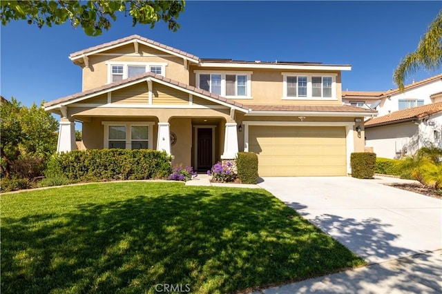 traditional-style home with a garage, stucco siding, a front yard, solar panels, and driveway