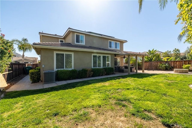 rear view of house with ceiling fan, central AC, a patio, a fenced backyard, and stucco siding