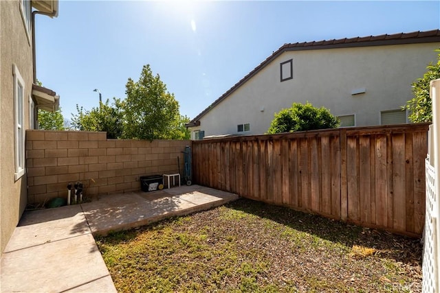 view of yard with a fenced backyard and a patio area