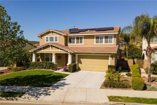 view of front of home featuring fence, a garage, stucco siding, roof mounted solar panels, and driveway