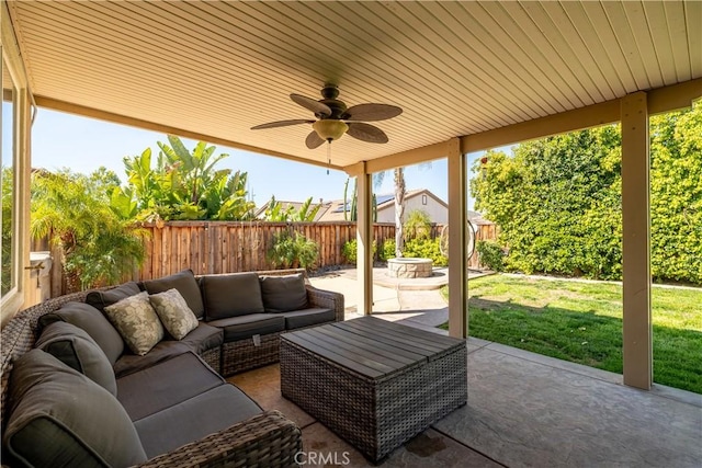 view of patio / terrace featuring ceiling fan, an outdoor living space, and a fenced backyard