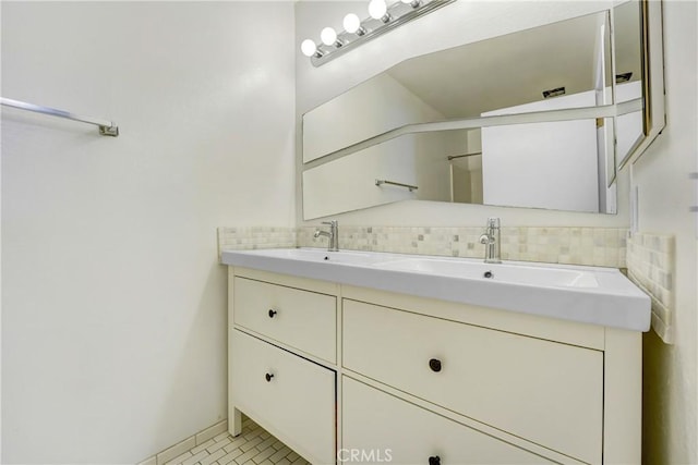 full bath featuring backsplash, double vanity, a sink, and tile patterned flooring