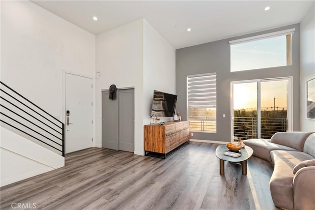 1055 S Serrano Ave Unit 502, Los Angeles, CA 90006 - living room with recessed lighting, wood finished floors, stairway, and a towering ceiling