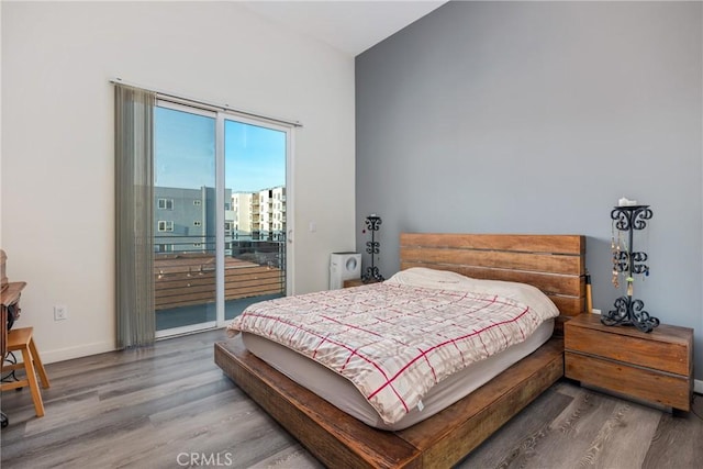 1055 S Serrano Ave Unit 502, Los Angeles, CA 90006 - bedroom featuring baseboards, wood finished floors, and access to exterior