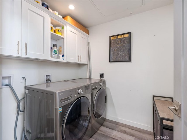 1055 S Serrano Ave Unit 502, Los Angeles, CA 90006 - washroom with cabinet space, washing machine and clothes dryer, attic access, baseboards, and wood finished floors