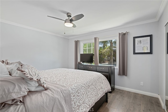 bedroom with ceiling fan, baseboards, ornamental molding, and wood finished floors