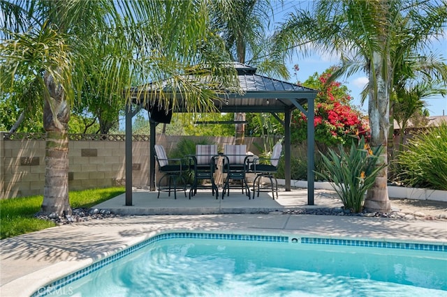 view of swimming pool with a patio, a gazebo, fence, and a fenced in pool