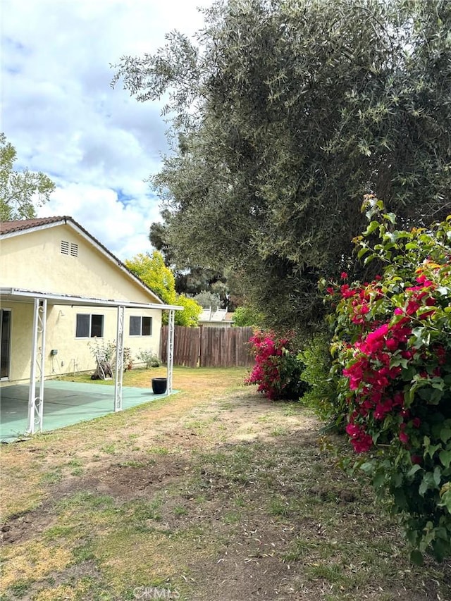 view of yard featuring a patio and fence