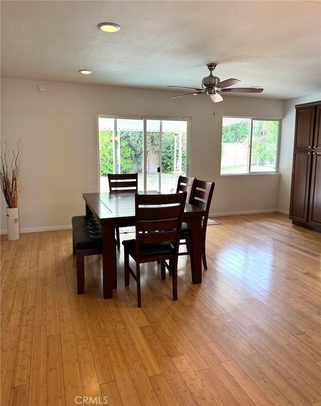 dining space featuring a ceiling fan, baseboards, recessed lighting, and light wood-style flooring