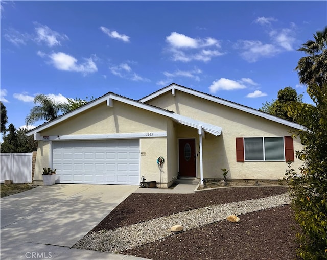single story home with fence, an attached garage, driveway, and stucco siding