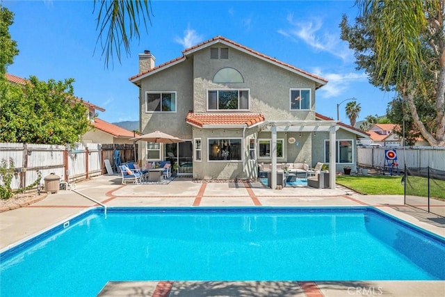 back of house with a pergola, stucco siding, a chimney, an outdoor hangout area, and a tiled roof