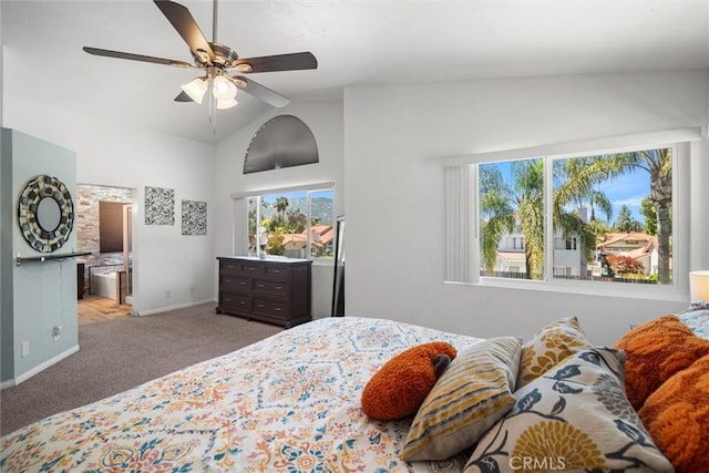 carpeted bedroom with connected bathroom, a ceiling fan, baseboards, and high vaulted ceiling