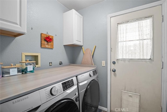 laundry area with cabinet space and separate washer and dryer