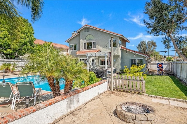 back of property with a patio area, a fenced backyard, an outdoor fire pit, a pergola, and stucco siding