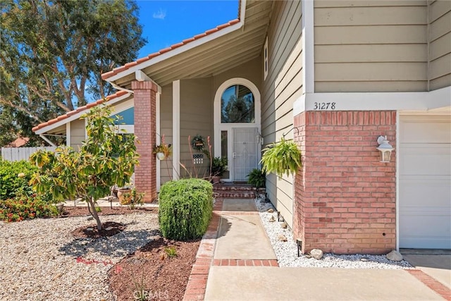 doorway to property featuring brick siding
