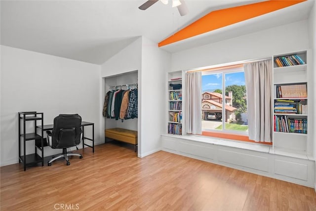 home office featuring a ceiling fan, vaulted ceiling, and wood finished floors