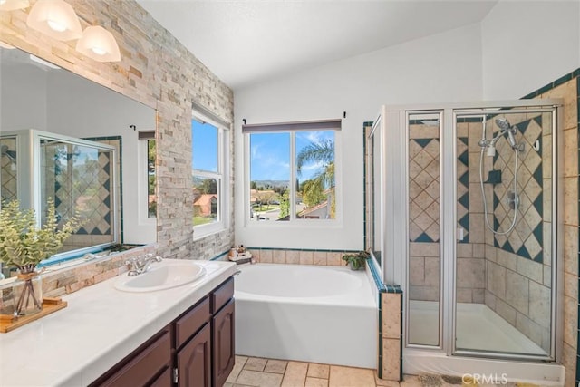 bathroom featuring vanity, a garden tub, lofted ceiling, and a shower stall