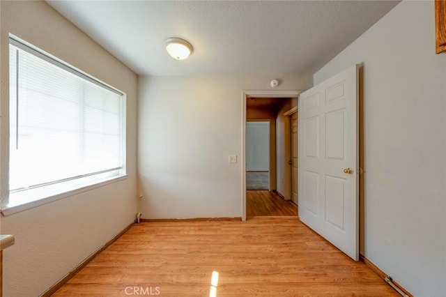 unfurnished room with light wood finished floors