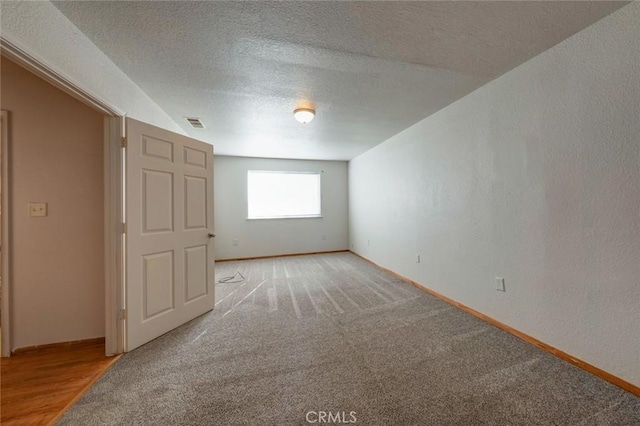 empty room with baseboards and light carpet