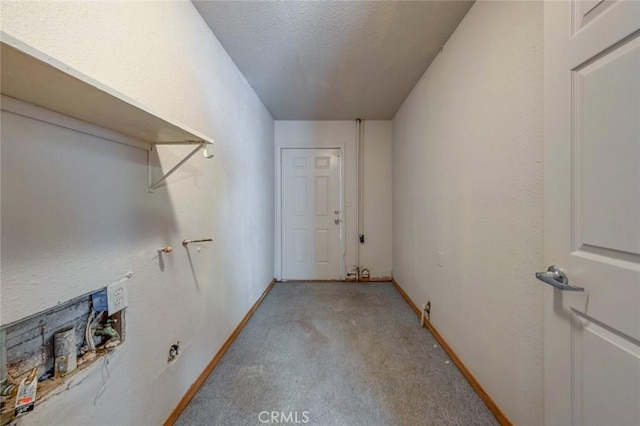 laundry area with a textured ceiling, baseboards, and light carpet