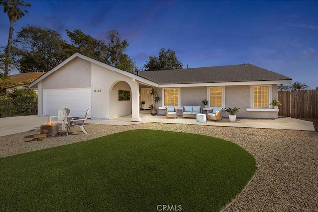18128 Cari Ln, Yorba Linda, CA 92886 - view of front of home with a garage, fence, stucco siding, an outdoor hangout area, and a yard