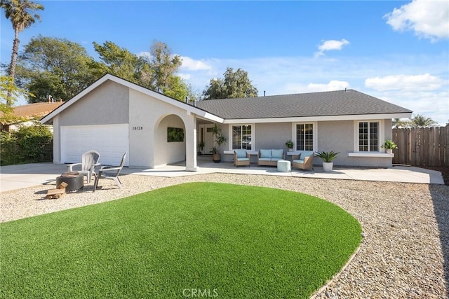 18128 Cari Ln, Yorba Linda, CA 92886 - rear view of house with fence, an attached garage, stucco siding, outdoor lounge area, and a yard