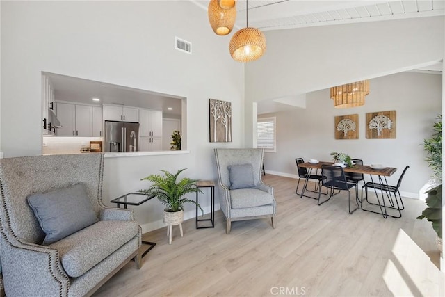 18128 Cari Ln, Yorba Linda, CA 92886 - sitting room with visible vents, light wood-type flooring, high vaulted ceiling, baseboards, and a chandelier