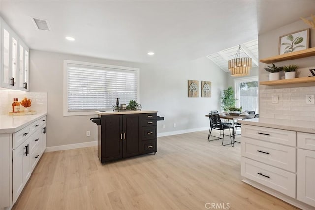 18128 Cari Ln, Yorba Linda, CA 92886 - kitchen featuring tasteful backsplash, light wood-type flooring, and white cabinetry