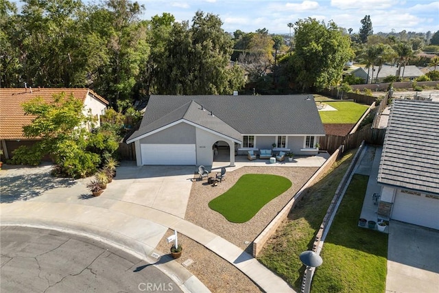 18128 Cari Ln, Yorba Linda, CA 92886 - view of front of house featuring a garage, a front lawn, a fenced backyard, an outdoor living space, and concrete driveway