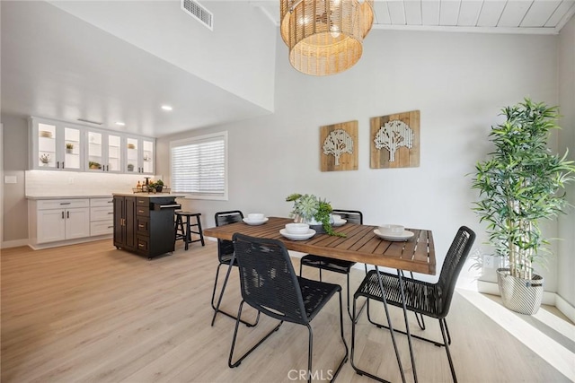 18128 Cari Ln, Yorba Linda, CA 92886 - dining space with visible vents, a towering ceiling, baseboards, recessed lighting, and light wood-style flooring