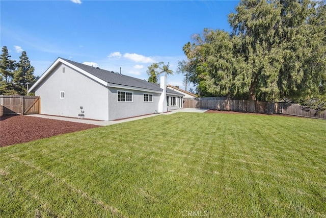18128 Cari Ln, Yorba Linda, CA 92886 - rear view of property featuring a lawn, a patio, a fenced backyard, and stucco siding