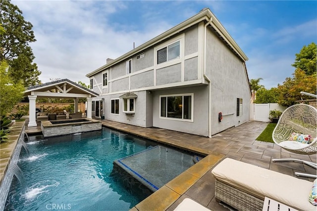 back of house with a fenced backyard, a patio, a gazebo, and a fenced in pool