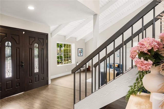 foyer entrance with recessed lighting, baseboards, stairs, wood finished floors, and beamed ceiling