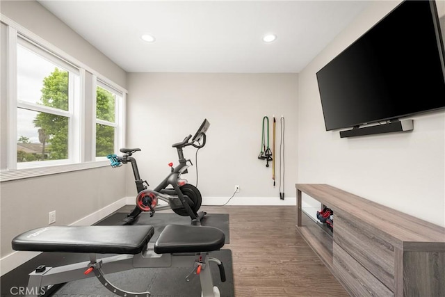 workout area featuring wood finished floors, baseboards, and recessed lighting