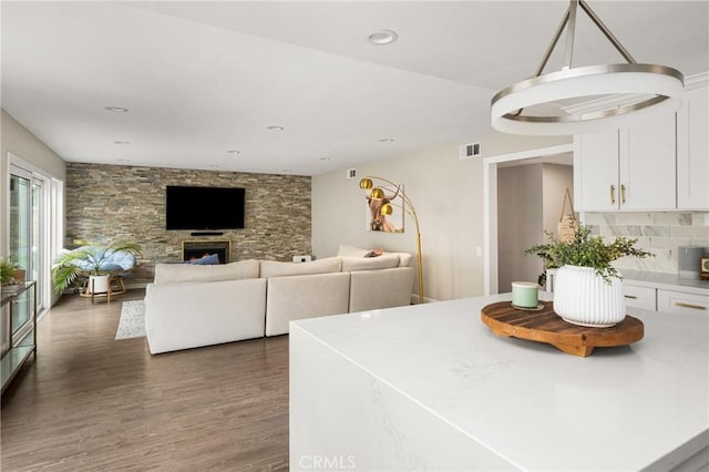 kitchen featuring white cabinets, light countertops, visible vents, and wood finished floors