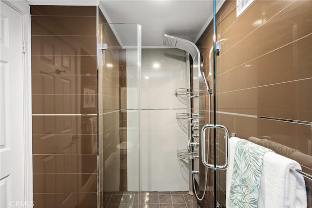 bathroom featuring a stall shower and ornamental molding