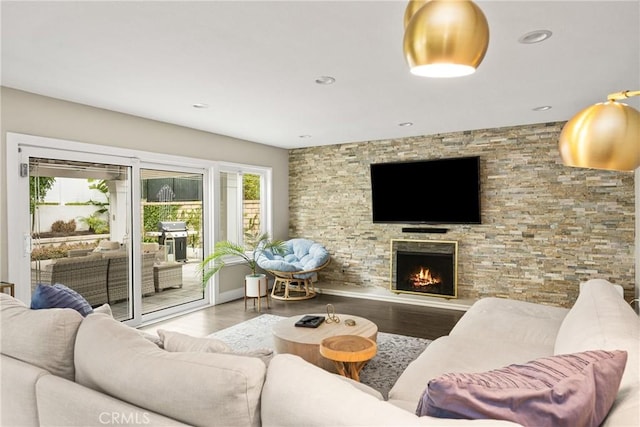 living room with a fireplace, recessed lighting, and wood finished floors