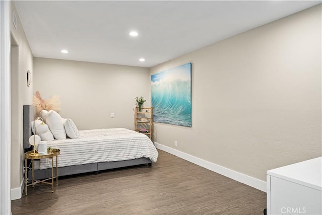 bedroom with wood finished floors, baseboards, and recessed lighting
