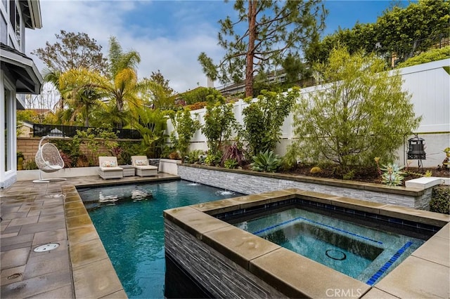 view of swimming pool with a fenced backyard, an in ground hot tub, a patio area, and a fenced in pool