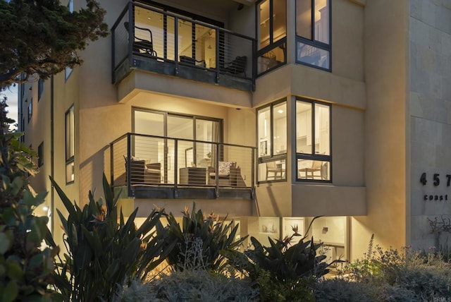 back of property with a balcony