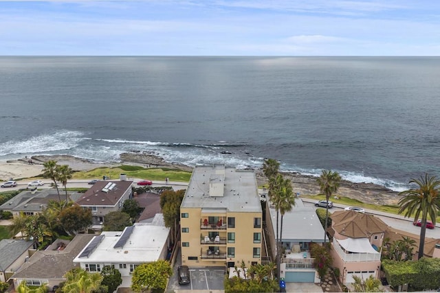 drone / aerial view with a beach view and a water view
