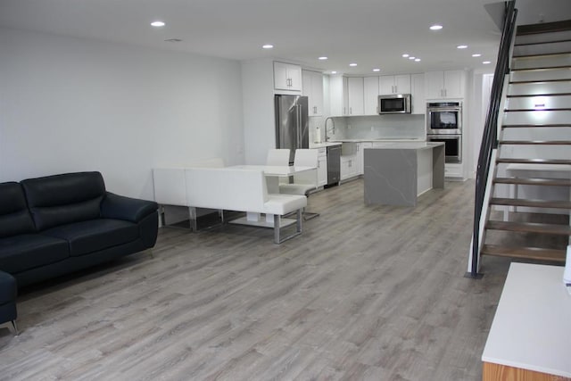 922 Sealane Dr Unit B, Encinitas, CA 92024 - living room featuring light wood-type flooring, stairway, and recessed lighting