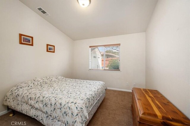 carpeted bedroom with visible vents, baseboards, and lofted ceiling