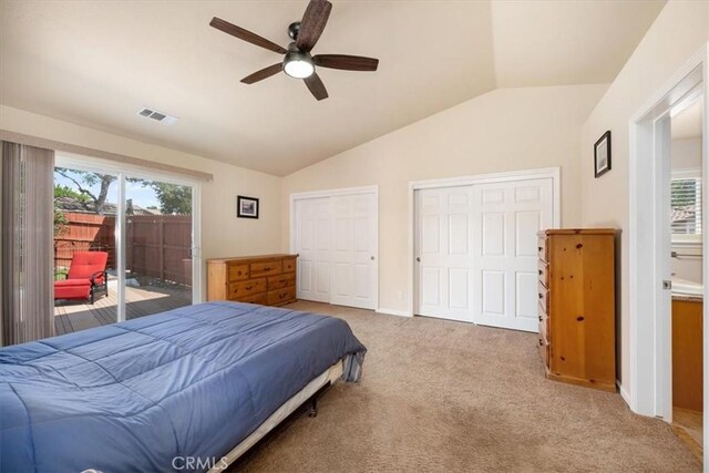 bedroom featuring access to outside, vaulted ceiling, multiple windows, and visible vents